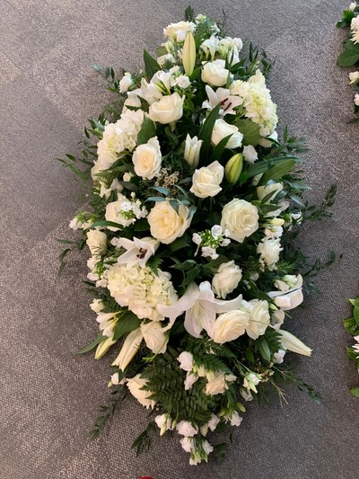 White and green stunning casket tribute